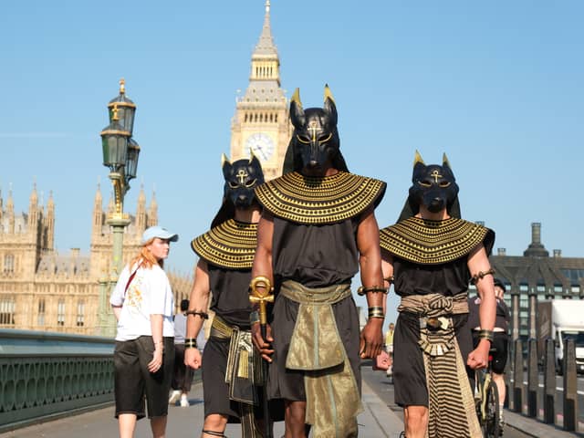 Performers dressed as the ancient Egyptian god Anubis surprise London commuters.