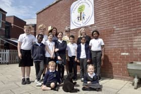 Milton Park Primary School in Portsmouth, has received a good Ofsted report with some outstanding elements.Pictured is: (back l-r) Ros Middleton, deputy headteacher, Anna Young, assistant headteacher and Wedny Fowler, headteacher with some of the children and Mabel the school well-being dog.Picture: Sarah Standing (180724-7326)