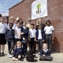 Milton Park Primary School in Portsmouth, has received a good Ofsted report with some outstanding elements.Pictured is: (back l-r) Ros Middleton, deputy headteacher, Anna Young, assistant headteacher and Wedny Fowler, headteacher with some of the children and Mabel the school well-being dog.Picture: Sarah Standing (180724-7326)