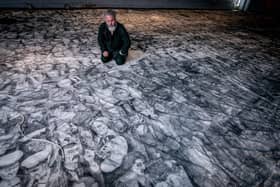 Peter Codling, a renowned Portsmouth-based artist who is currently finalising his extraordinary piece of art, hand-drawn on a replica sail of HMS Victory on Thursday 18th July 2024Pictured: Pete Codling with his artwork at the Historic Dockyard Picture: Habibur Rahman