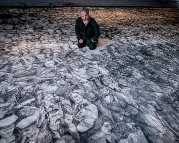 Peter Codling, a renowned Portsmouth-based artist who is currently finalising his extraordinary piece of art, hand-drawn on a replica sail of HMS Victory on Thursday 18th July 2024Pictured: Pete Codling with his artwork at the Historic Dockyard Picture: Habibur Rahman