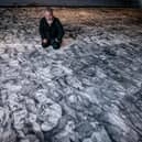 Peter Codling, a renowned Portsmouth-based artist who is currently finalising his extraordinary piece of art, hand-drawn on a replica sail of HMS Victory on Thursday 18th July 2024Pictured: Pete Codling with his artwork at the Historic Dockyard Picture: Habibur Rahman