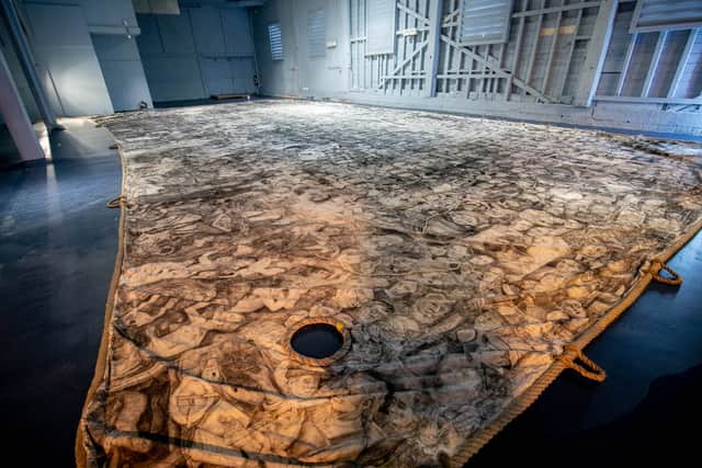 Peter Codling, a renowned Portsmouth-based artist who is currently finalising his extraordinary piece of art, hand-drawn on a replica sail of HMS Victory 
Pictured: Pete Codling's artwork at the Historic Dockyard Picture: Habibur Rahman