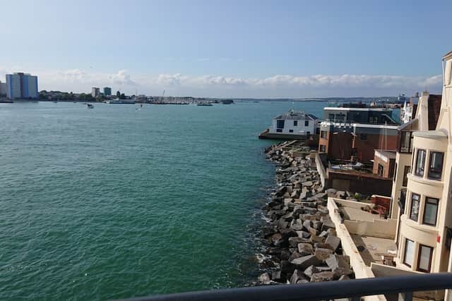 A picture of empty sea from The Round Tower in Old Portsmouth, with people waiting to see the Royal Navy destroyer HMS Dauntless leave Portsmouth.