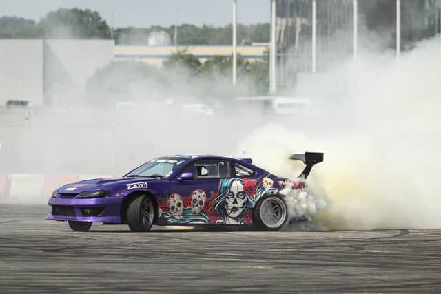 A stunt driver takes part in a drifting exhibition during the first day of the British Motor Show at Farnborough International Exhibition Centre on August 17, 2023 in Farnborough, England. The UK's premier family-friendly automotive extravaganza is back with its annual showcase, featuring supercar parades, stunt shows, live auctions, expert advice on sustainable motoring options, and giving speed enthusiasts the chance to test drive the latest models. (Photo by Leon Neal/Getty Images)