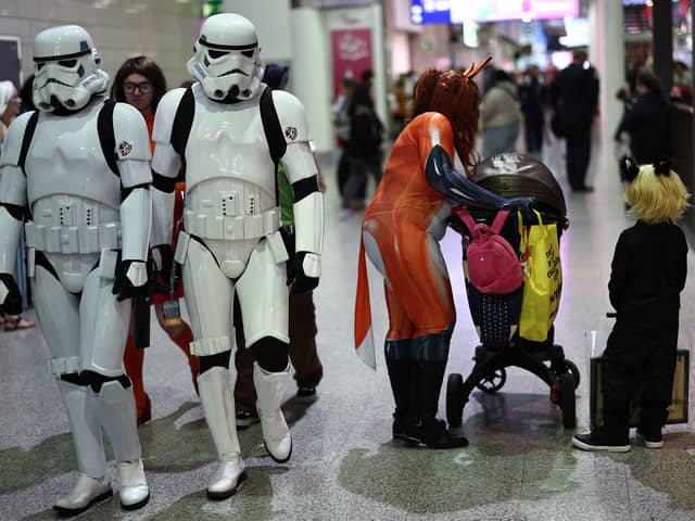 Cosplayers attend the MCM Comic Con at ExCeL exhibition centre in London on October 27, 2023. (Photo by HENRY NICHOLLS / AFP) 