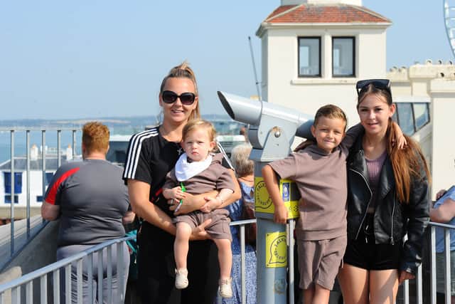 Pictured is: Jade Collins with Arnie (1), Brodie (5) and Maicey (13). They were waiting to see Kieron aboard HMS Prince of Wales. Picture: Sarah Standing (010824-2868)