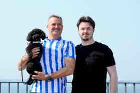 HMS Prince of Wales was scheduled to leave Portsmouth for Scotland at 9.55am on Thursday, August 1, 2024, but this has been delayed until 10pm. Pictured is: (left) Richard Middleton with his son George Middleton and their toy poodle Baz (2) who travelled down from Barnsley to see off son and brother Oscar.