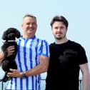 HMS Prince of Wales was scheduled to leave Portsmouth for Scotland at 9.55am on Thursday, August 1, 2024, but this has been delayed until 10pm. Pictured is: (left) Richard Middleton with his son George Middleton and their toy poodle Baz (2) who travelled down from Barnsley to see off son and brother Oscar.