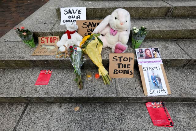 Flowers and placards lefts on the Guildhall steps to honour the three victims killed in Southport. Some messages contained anti-immigration slogans and called prime minister Sir Keir Starmer "scum". Picture: Chris  Moorhouse (030824-39)