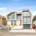 The listing says: "A stunning bespoke designed detached house, enviably situated on the seafront offering superb coastal views and excellent access to the beach opposite."