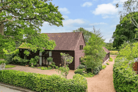 The listing says: "With a perfect combination of charm and character, as well a layout that offers both versatility and flexibility for any growing family, Clarendon Barn is surrounded by countryside and comes with approaching one and a half acres of mature gardens with two adjoining paddocks." 