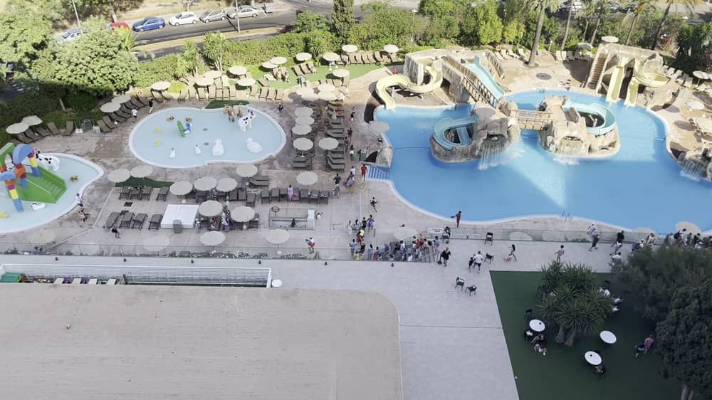 Tourists race to get sunbeds after queuing for pool to open.