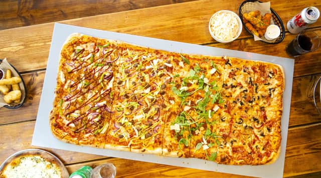 The Yard Pizza generally serves four to six adults although two people have eaten a whole one in the past.