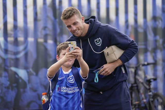 The injured Conor Shaughnessy poses with a young Pompey fan. Picture: Jason Brown/ProSportsImages