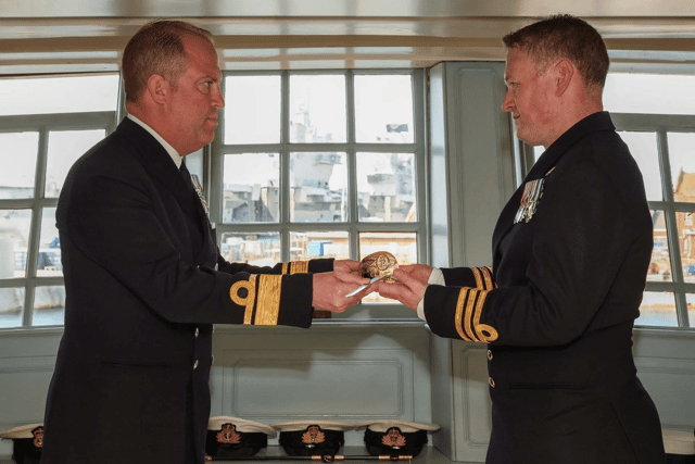 Rear Admiral Robert Pedre (Commodore UK Strike Force) presents the FIRMIN Sword of Peace to Commander Richard Skelton (Coastal Forces Squadron Commanding Officer).