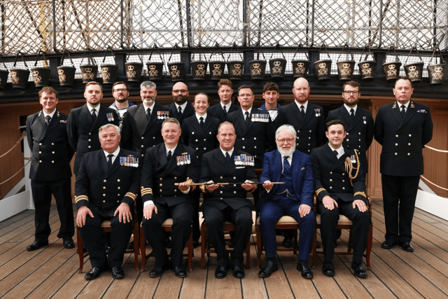 Royal Navy sailors based in Portsmouth have received a prestigious accolade after recovering migrant boats in the English Channel. Pictured: Rear Admiral Robert Pedre (Commodore UK Strike Force) with the Coastal Forces Squadron and Mr Tony Kelly.