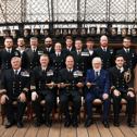 Royal Navy sailors based in Portsmouth have received a prestigious accolade after recovering migrant boats in the English Channel. Pictured: Rear Admiral Robert Pedre (Commodore UK Strike Force) with the Coastal Forces Squadron and Mr Tony Kelly.
