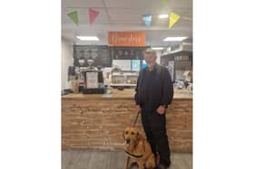 A community centre has chosen to honour a much-loved service dog by naming the café after him. The new name was voted for by the community, with the dog always accompanying his owner Matt until Matt's passing in 2022. Brewster is pictured with new owner Steve at the cafe named in his honour.