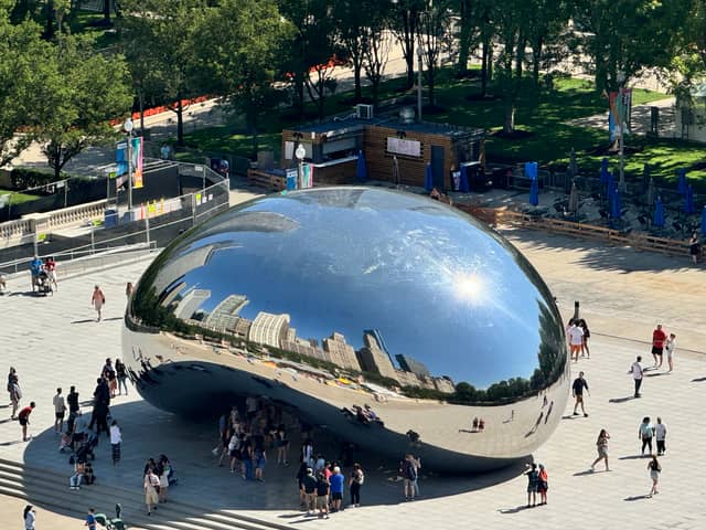 Chicago cityscape reflected in iconic Cloud Gate monument, known as 'The Bean'