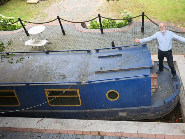 Stephen Cuddy with the mini canal lock he built to house a narrowboat turned into a swimming pool.