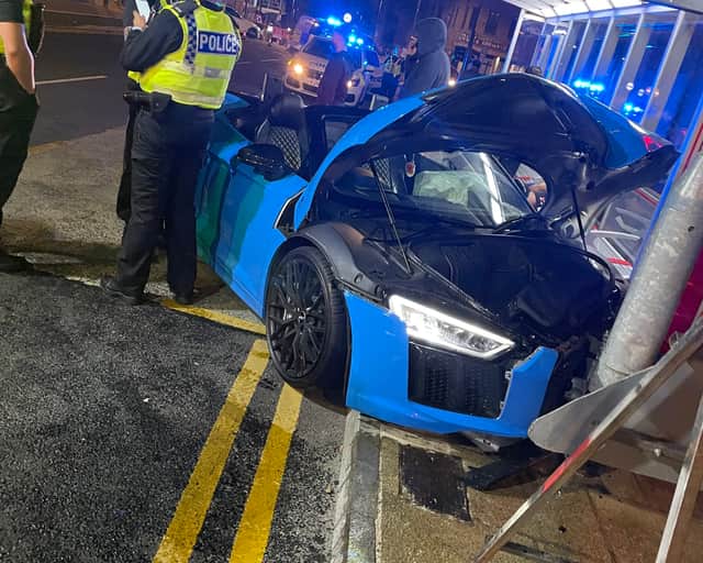 A light blue Audi R8 supercar hit a street post.