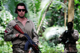 A Royal Marine from HMS-Lancaster and a Seychelles Special Forces Unit soldier move through the jungle during an exercise.