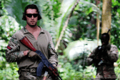 A Royal Marine from HMS-Lancaster and a Seychelles Special Forces Unit soldier move through the jungle during an exercise.