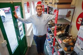 Oliver Salter, 31, who owns Peter Scott shoe shop in Woodhall Spa, Lincolnshire, Britain's smallest shoe shop.