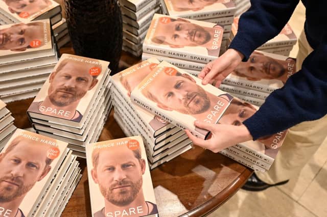 Prince Harry Spare: When does it come out in paperback and are there any new additions? A bookseller holds a copy of "Spare" by Britain's Prince Harry, Duke of Sussex, at Waterstones' flagship Piccadilly bookshop on the day of its release in London, on January 10, 2023