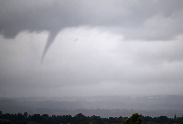 A funnel cloud is seen north of the racecourse on Qipco British Champions Day at Ascot Racecourse, west of London on October 21, 2023.