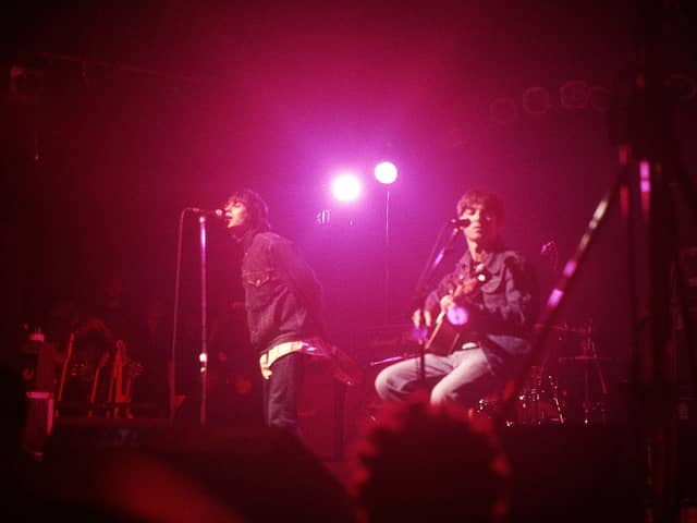 Liam Gallagher and Noel Gallagher of Oasis perform on stage at The Electric Ballroom, Camden on May 9 1996 (Photo by Getty Images) 