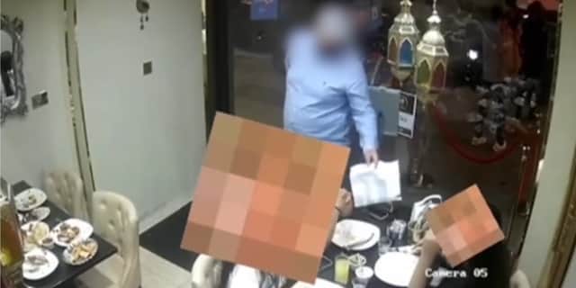 Man allegedly distracts diners before ‘swiping phone’.