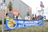 Members of the RMT and Nautilus International unions have gone on strike on Merchant Navy Day over pay and conditions for Royal Fleet Auxiliary sailors. Talks have been held with the Ministry of Defence, but a pay offer has yet to be issued. 

Pictured is: (l-r) Martyn Gray, Olly Longden, Andy Rawlinson and Mark Brennan, striking in Wharf Road near Whale Island, Portsmouth, on September 3