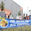 Royal Fleet Auxiliary sailors - who support the Royal Navy - have accepted a fresh pay offer from the MoD after months of negotiations. Pictured are members of the RMT and Nautilus International unions on strike in Portsmouth over pay and conditions on September 3. From L: Martyn Gray, Olly Longden, Andy Rawlinson and Mark Brennan, striking in Wharf Road near Whale Island, Portsmouth.