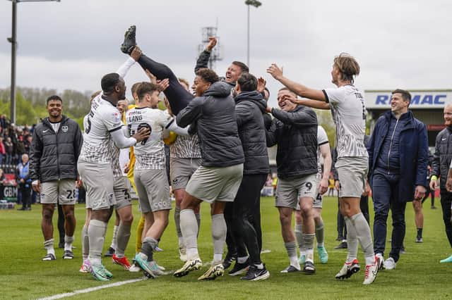 Pompey's players lift Jon Harley in the air as they celebrate the end of their 2023-24 title-winning season. Picture: Jason Brown/ProSportsImages