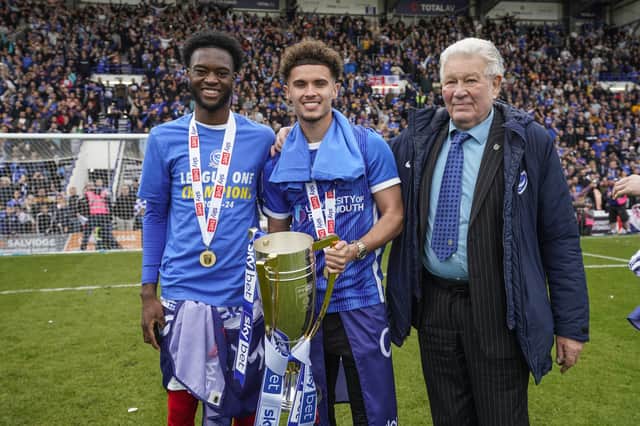Josh Martin poses with the League One trophy with Abu Kamara (left) and Barry Harris (right). Picture: Jason Brown/ProSportsImages