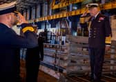 King Charles III saluting Commander Officer James Collie as he boards the Vanguard-class submarine during a visit to the Royal Naval Armaments Depot, Coulport, part of HM Naval Base Clyde. Picture date: Thursday September 19, 2024.