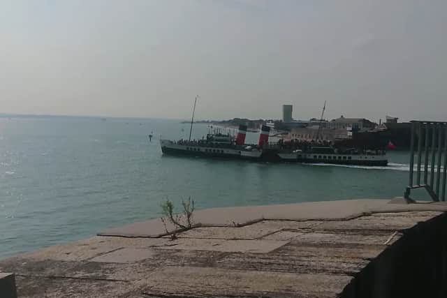 PS Waverley sailing alongside Portsmouth as she continues her summer season on the south coast.
