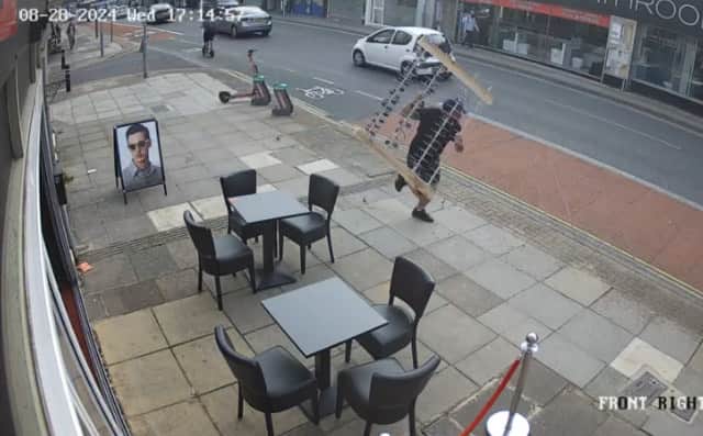 Thief holding rack of designer sunglasses is chased down London Road in Portsmouth