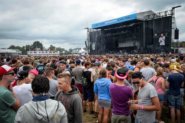 People gather for a concert on the first day of the three-day Pukkelpop music festival in Hasselt, northeastern Belgium on August 15, 2013.