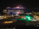 Resilient Lady, operated by Virgin Voyages, sailing past Portsmouth during Victorious Festival, with an illuminated messages "Pompey" seen by festival-goers.