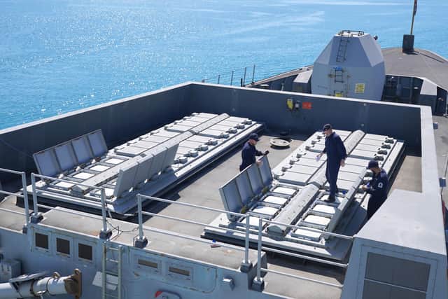 Members of the ships company performing routine maintenance on the pods containing sea viper surface to air missiles aboard HMS Duncan.