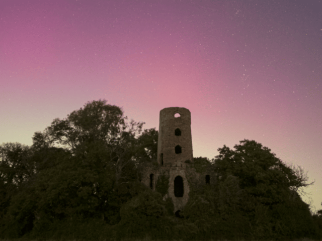 Northern Lights over Racton Ruins in Chichester as Aurora Borealis passes over UK.