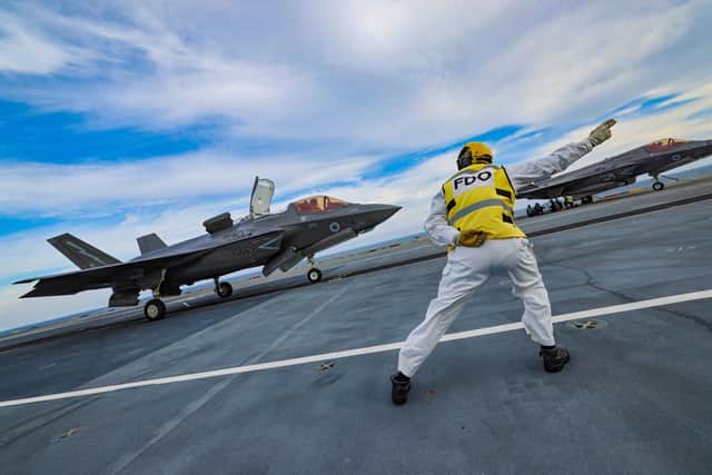 Pictured: The Flight Deck Officer (FDO) launching the F35 seconds before take off. 809 NAS and 617 SQN pilots conduct Carrier Qualifications (CQs) on HMS Prince of Wales, preparing to join the UK Carrier Strike Group.
