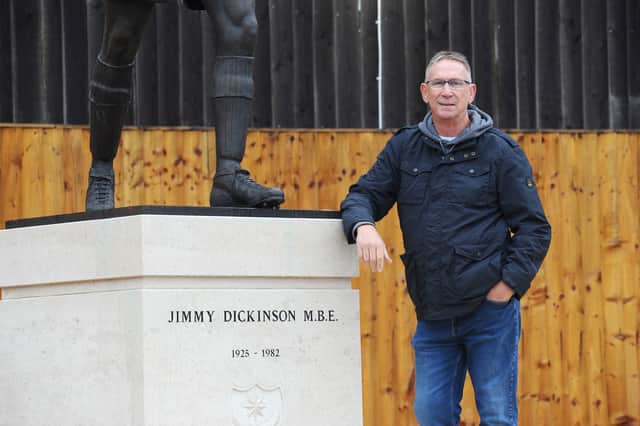 Alan Knight picture the statue of another Pompey Legend - Jimmy Dickinson. Picture: Sarah Standing