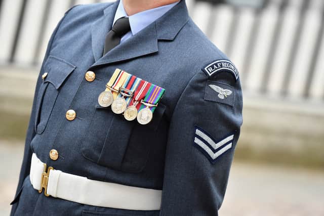 A female senior RAF officer who was told to "grow a pair" and was subject to sexist language by email has been awarded a pay-out.