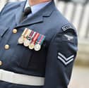A female senior RAF officer who was told to "grow a pair" and was subject to sexist language by email has been awarded a pay-out.