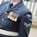 A female senior RAF officer who was told to "grow a pair" and was subject to sexist language by email has been awarded a pay-out.