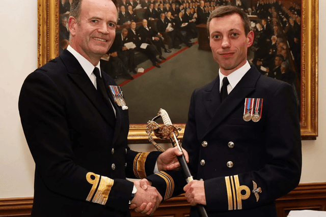 Lt Cdr George Lunn receives the FAA Sword from Rear Admiral Anthony Rimmington for his role in defending merchant ships from Houthi rebels while being deployed with HMS Diamond.